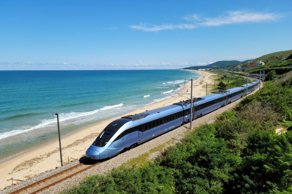 Electric train running along a coastal railway line